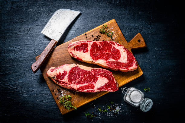 istock Raw beef steak fillets on black table 1363860575