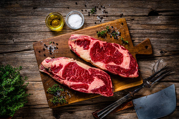 istock Two raw juicy beef steak fillets, spices and herbs 1363860601