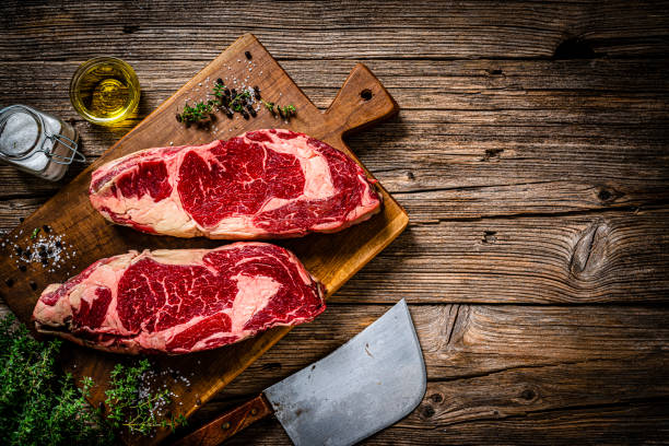 istock Two raw juicy beef steak fillets on wooden table 1363860607