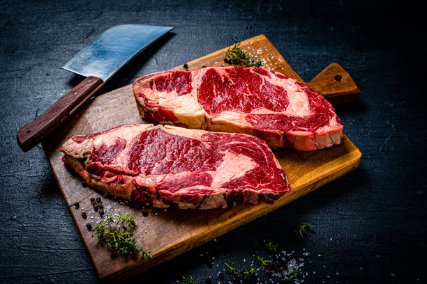istock Raw juicy beef steak fillets on black table 1363860614