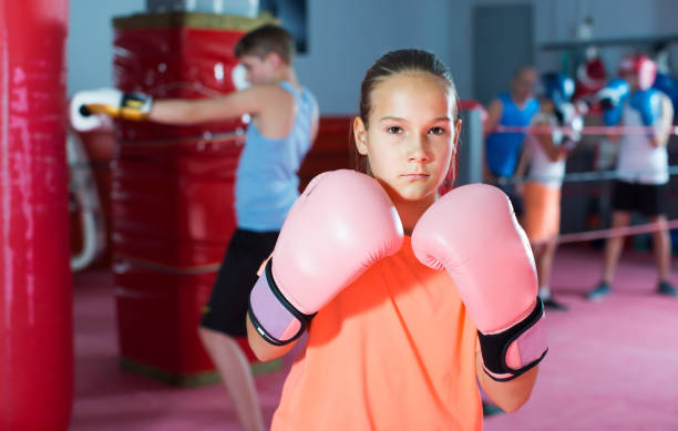 istock Ordinary girl boxer in boxing hall 1363861168
