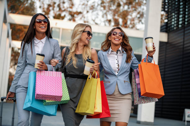Portrait of smiling businesswomen with shopping bags stock photo