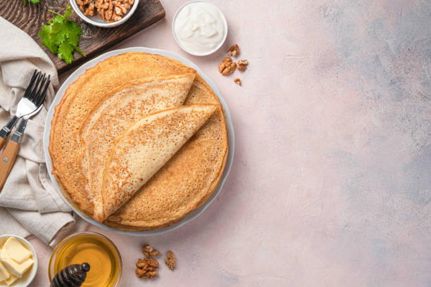 istock Traditional Russian blini on a light background with sour cream, honey and nuts 1363861381