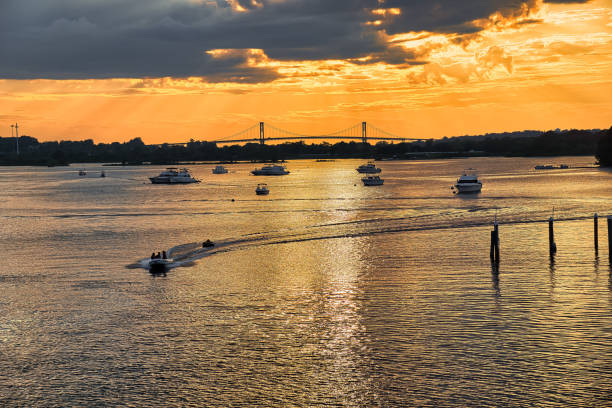 Golden Sunset Portsmouth Rhode Island Golden Sunset Portsmouth Rhode Island, Pell Bridge, and Boats rhode island stock pictures, royalty-free photos & images