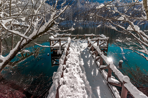 Winter Reflection with Sun and Pier at Yedigöller in Bolu in Turkey in Winter