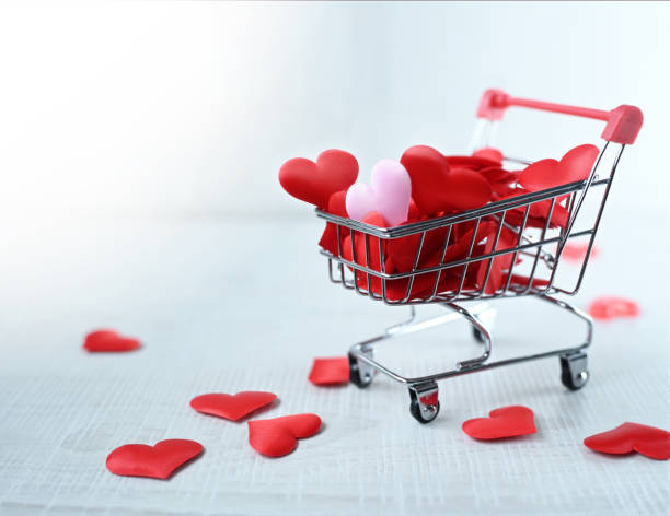 istock Shopping trolley with pink hearts isolated on grey background. 1363865744