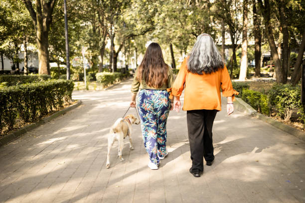 istock Mother and daughter walking at the park 1363868447