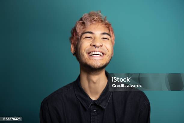 Cheerful Young Man Smiling On Blue Background Stock Photo - Download Image Now - Men, Portrait, Asian and Indian Ethnicities