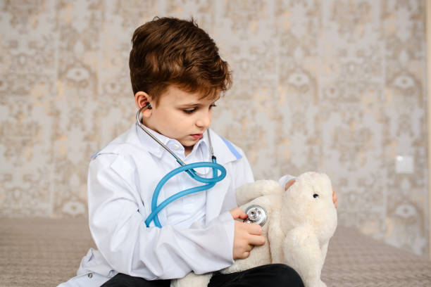 istock Little boy in white medical robe having fun 1363870842