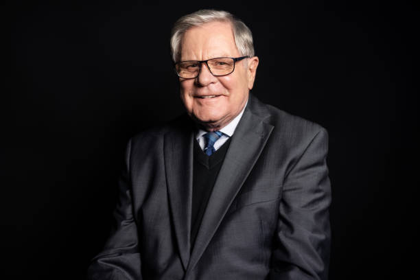 istock Senior businessman portrait looking at camera on black background 1363870961