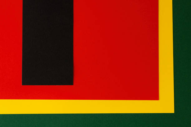 Abstract geometric background. Black vertical stripe with copy space on red, yellow, green color background. Black History Month background