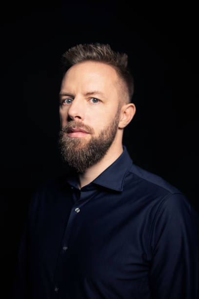 istock Portrait of a young man with a beard looking serious at camera 1363871207
