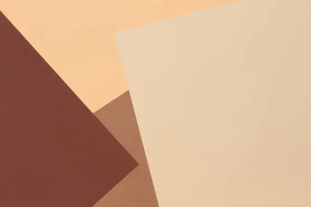 Photo of Color papers geometry composition banner background with beige, light brown and dark brown tones.