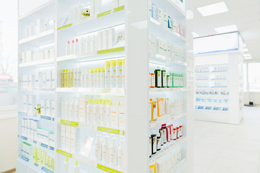 Modern new white drugstore pharmacy without clients visitors customers with shelves full of drugs medicines remedy antibiotics painkillers