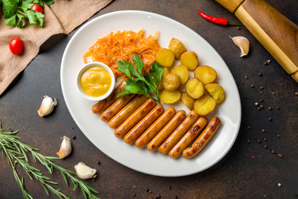 istock fried viennese sausages with fried cabbage and potatoes on white plate top view 1363873551