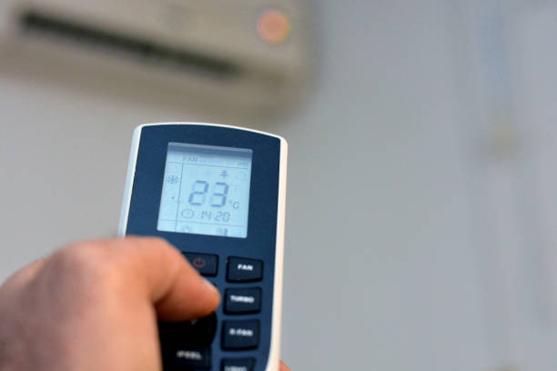 istock a human hand with its thumb pressing an air conditioner remote control to turn on the air conditioning fan and to adjust the room temperature 1363875370