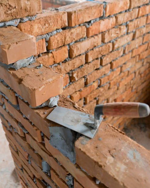 istock Brickwork of brick, folded in a certain way and fixed with mortar. industrial brick placing brick on cement in the construction of external walls, industry details 1363876230