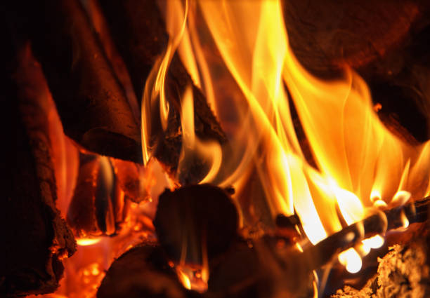 istock Firewood burns brightly in fireplace, relax 1363877928