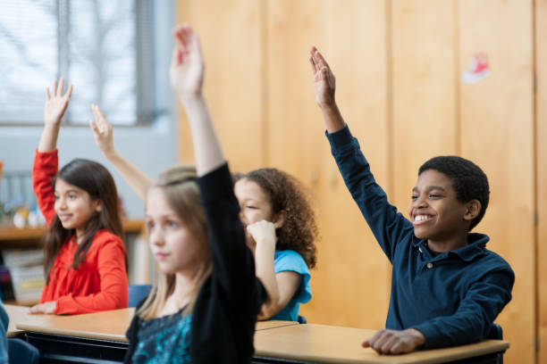istock Children raising their hands in class 1363879150