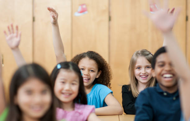 istock Children raising their hands in class 1363879152