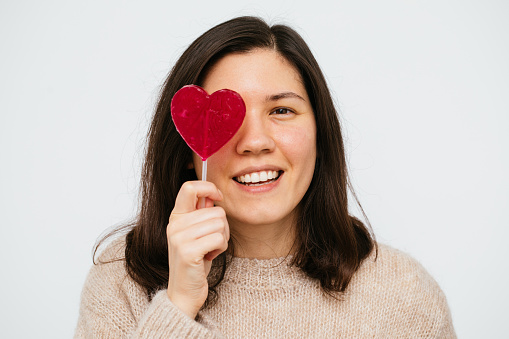 Beautiful Woman Holding Heart Shape Candy