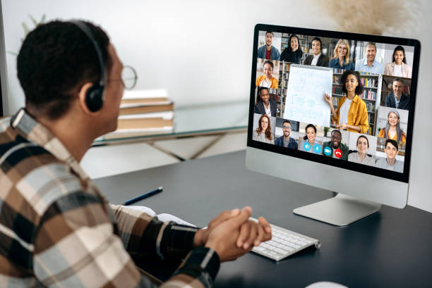 istock Online education, webinar, lecture. Male student studying online, on computer screen are multiracial people, female teacher conducts online lesson for students by video call, virtual learning concept 1363885048