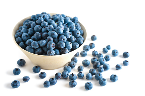 Fresh ripe organic blueberries in bowl on isolated on white background with copy space for text