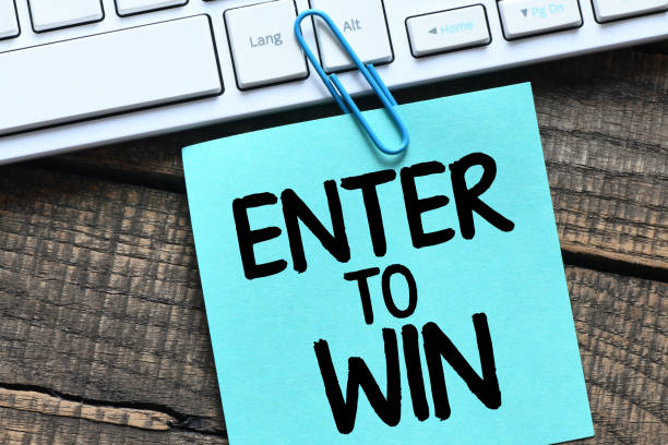 istock ENTER TO WIN words on a small piece of paper. 1363887148