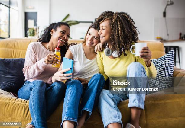 Cheerful Multiracial Female Friends Enjoying Free Time Together At Home Stock Photo - Download Image Now