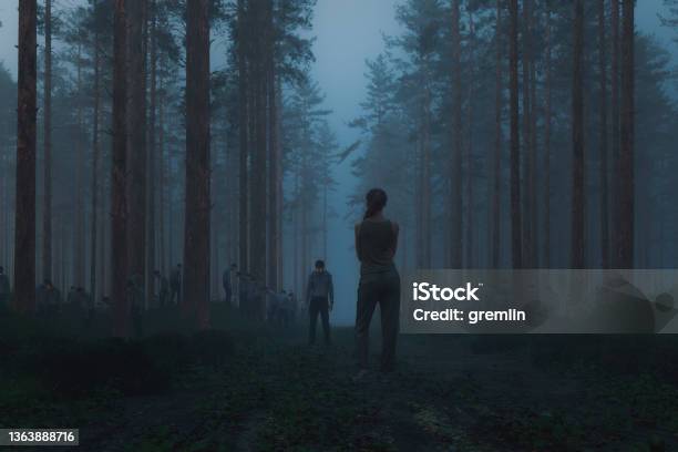 Woman Standing In The Spooky Forest With Hordes Of Zombies Stock Photo - Download Image Now