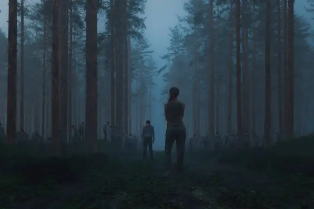 Photo of Woman standing in the spooky forest with hordes of zombies