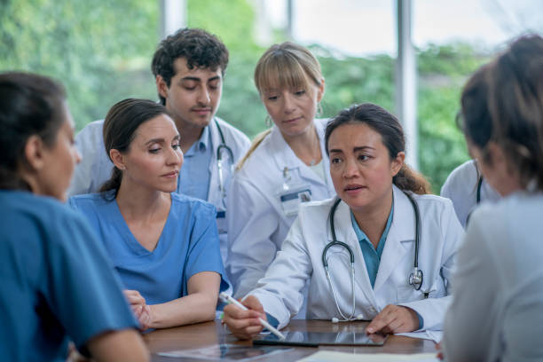 istock Diverse group of medical staff discussing 1363890684