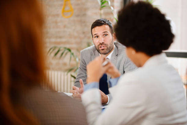 istock Multi-ethnic group of business persons discussing business 1363891480
