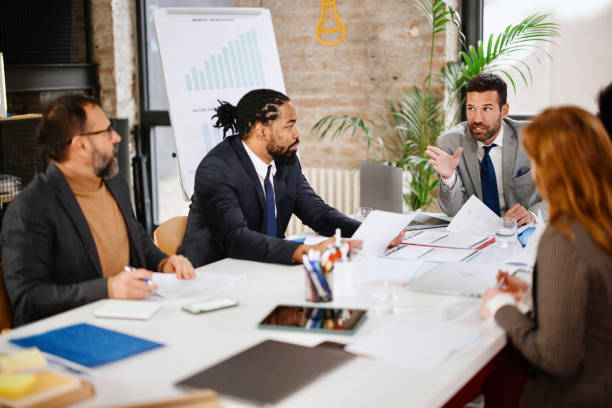 istock Multi-ethnic group of business persons discussing business 1363891481