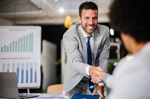 Business people shaking hands in office