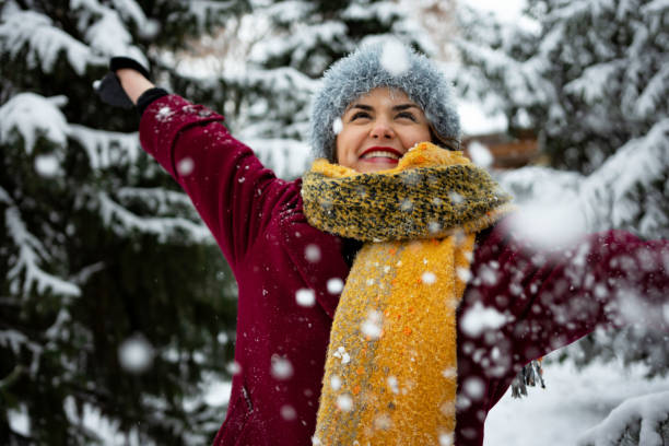 istock Happy young woman playing with snow 1363893390