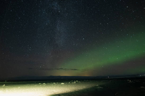 Milky Way and the Northern Lights outside Vik Iceland The Northern lights outside of Vik Iceland in December 2021 aurora borealis orange stock pictures, royalty-free photos & images