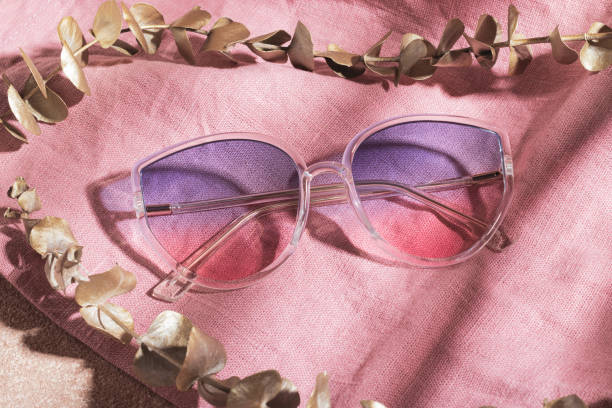 istock Transparent frame gradient sunglasses on pink cotton fabric 1363894341