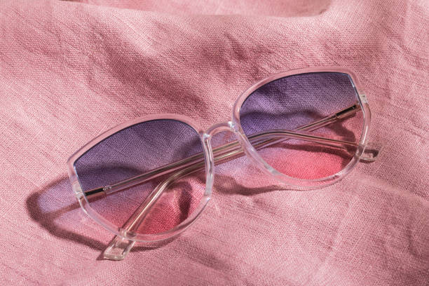 istock Transparent frame gradient sunglasses on pink cotton fabric 1363894349