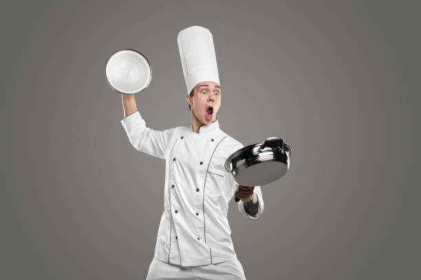 istock Crazy chef preparing food in frying pan 1363894447
