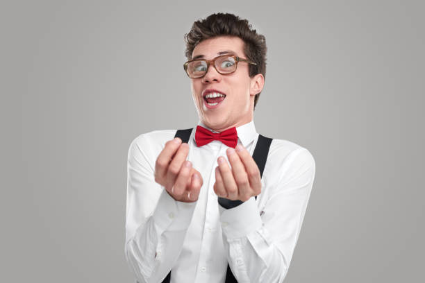 istock Greedy nerd rubbing fingers and smiling 1363894475