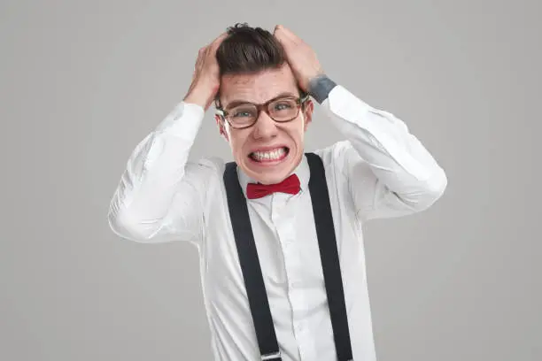 Photo of Mad young man tearing hair