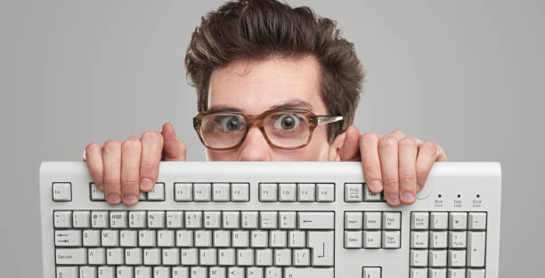 istock Funny geek man with keyboard 1363894493