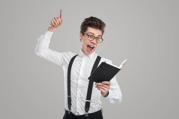 istock Excited man with notebook and pen 1363894508