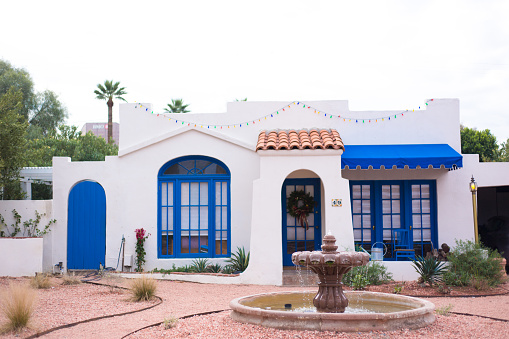 Phoenix, AZ: Traditional adobe whitewashed house with a Mexican fountain in the Willo Historic District of Phoenix.