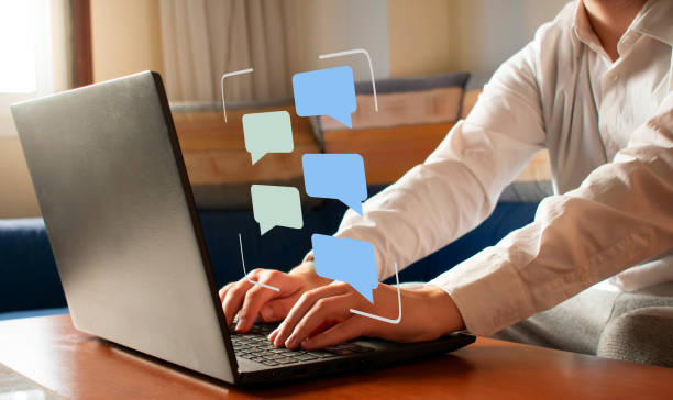 Chatting concept. Message bubbles floating of a laptop, simulating a conversation. Chatting concept. Message bubbles floating of a laptop, simulating an online conversation. Unrecognizable model. online messaging stock pictures, royalty-free photos & images