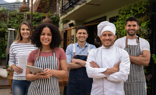 istock Group of food service workers smiling at a restaurant 1363895166
