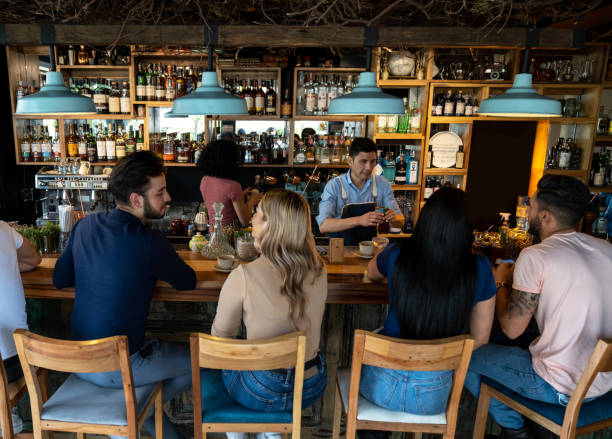 istock People having drinks at the bar while waiting for a table at the restaurant 1363895190