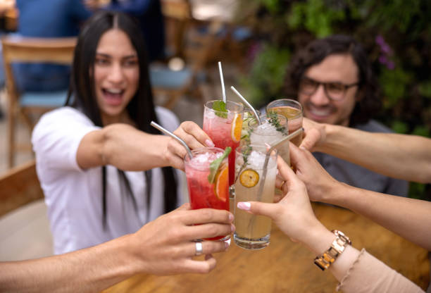 istock Group of friends having drinks at a bar and making a toast 1363895243