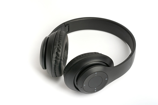 Auriculares inalámbricos en la oreja aislados con cuero negro sobre un fondo blanco. photo